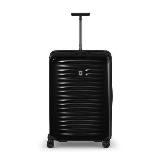 Black hard-shell rolling suitcase with horizontal ridges and an extendable handle.