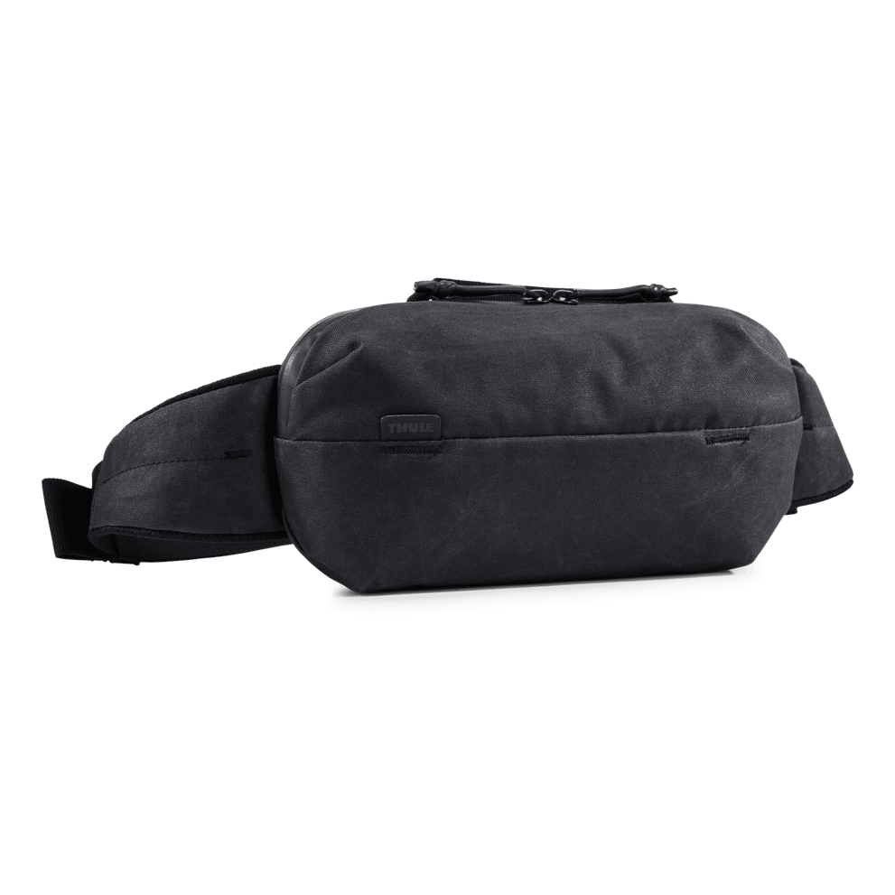 Thule Aion sling bag black, angled view showing the metal closure