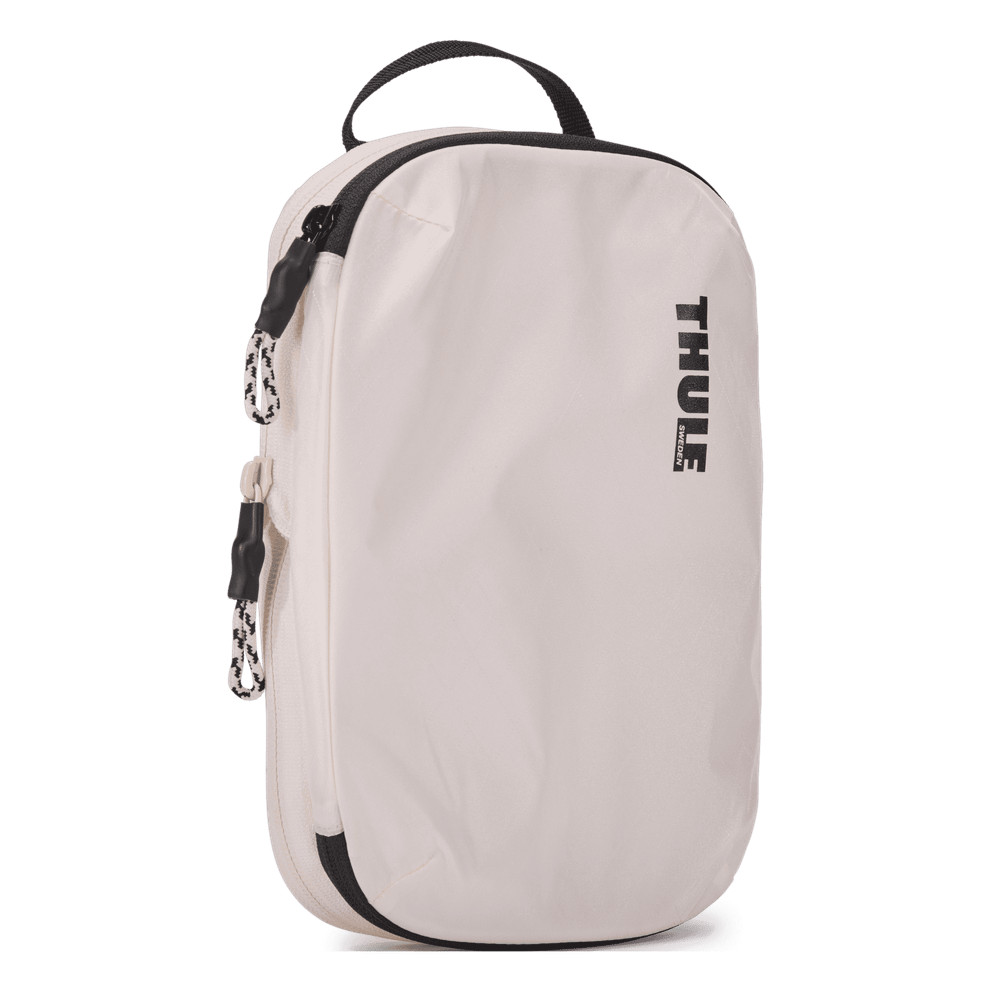 Thule compression packing cube small in white, three-quarter view with the webbing grab handle
