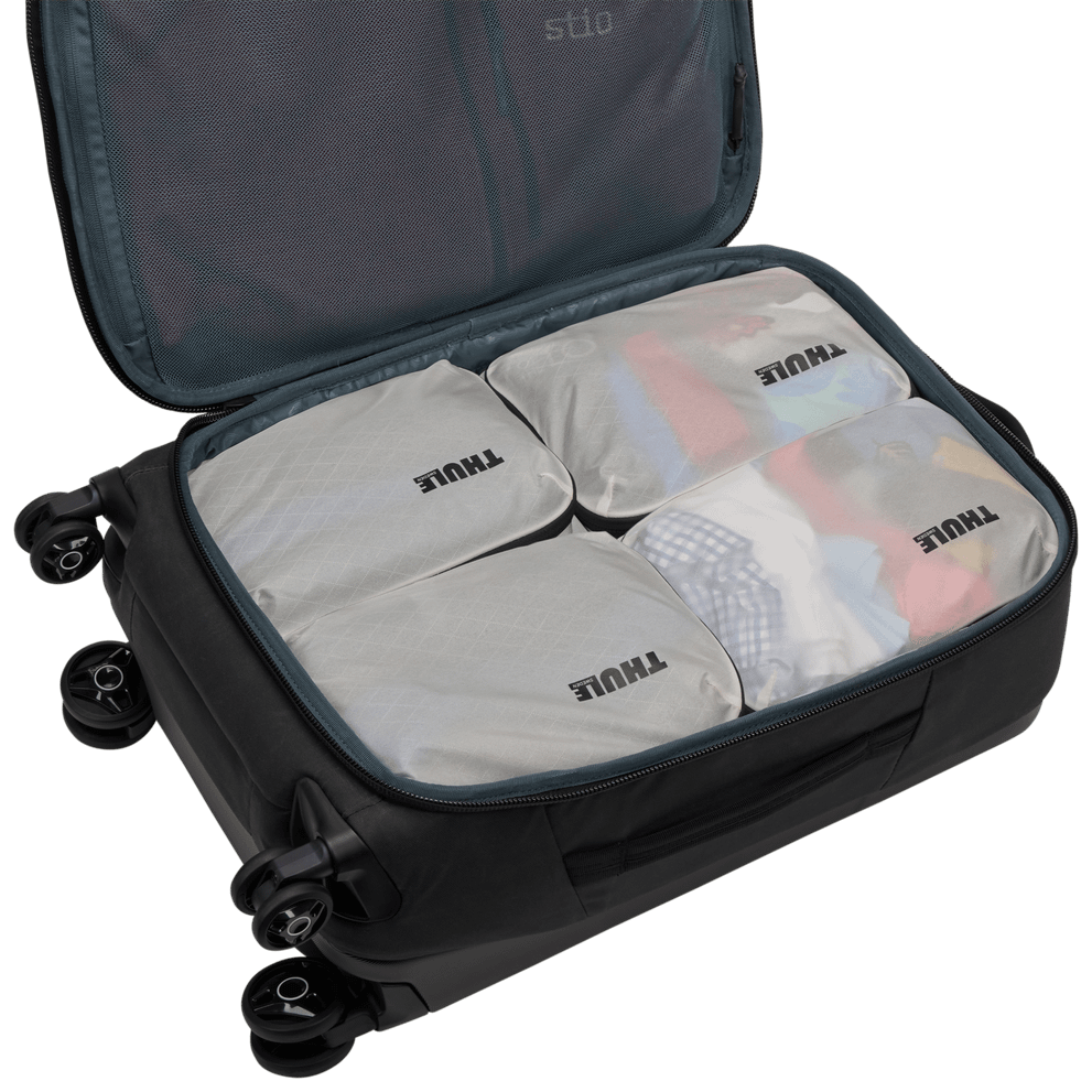 Thule compression packing cube small in white, semitransparent fabric showing socks and underwear