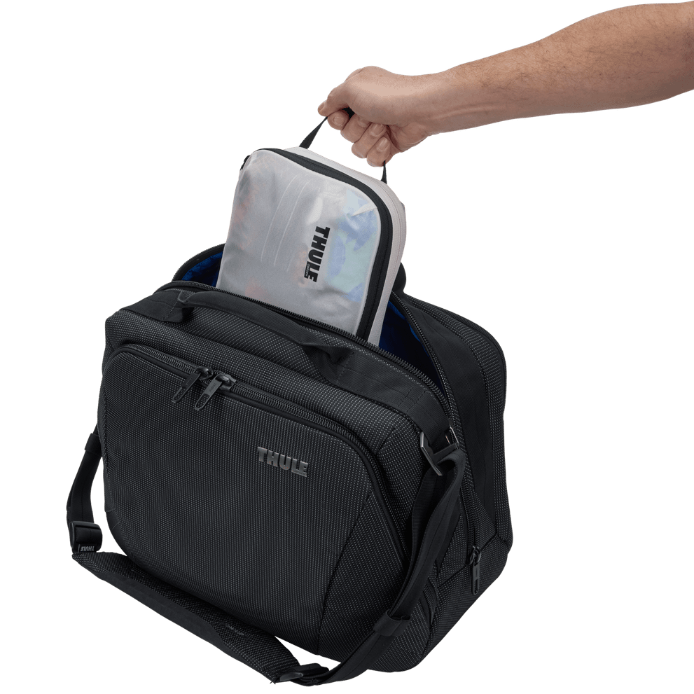 Thule compression packing cube small in white, several cubes arranged inside carry-on luggage