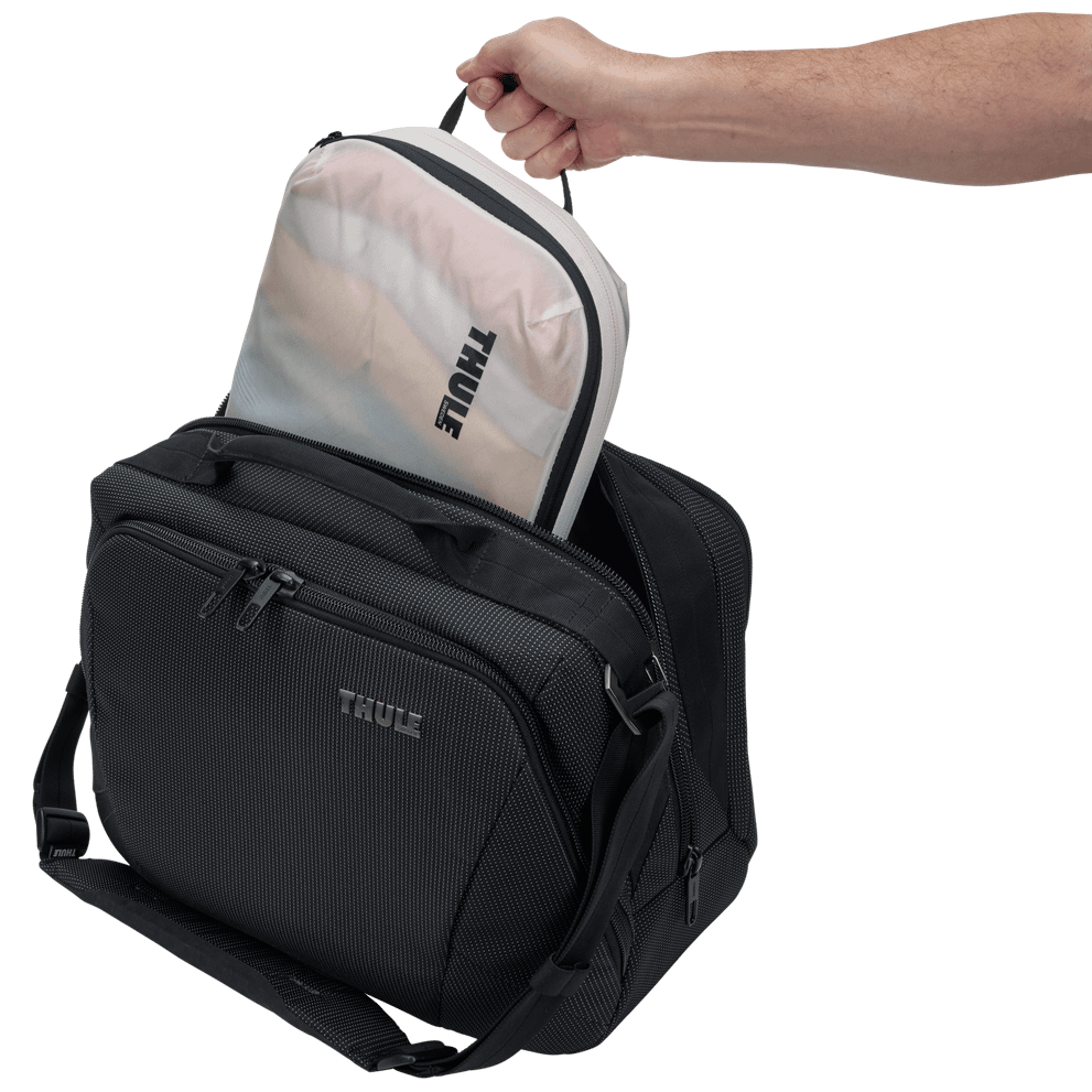 Thule compression packing cube medium in white, packed inside a suitcase