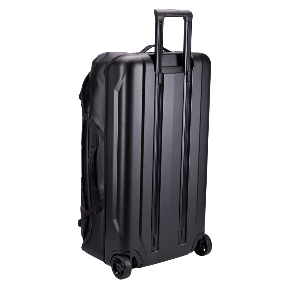 Thule Chasm rolling duffel 110L black, rear view with oversized wheels