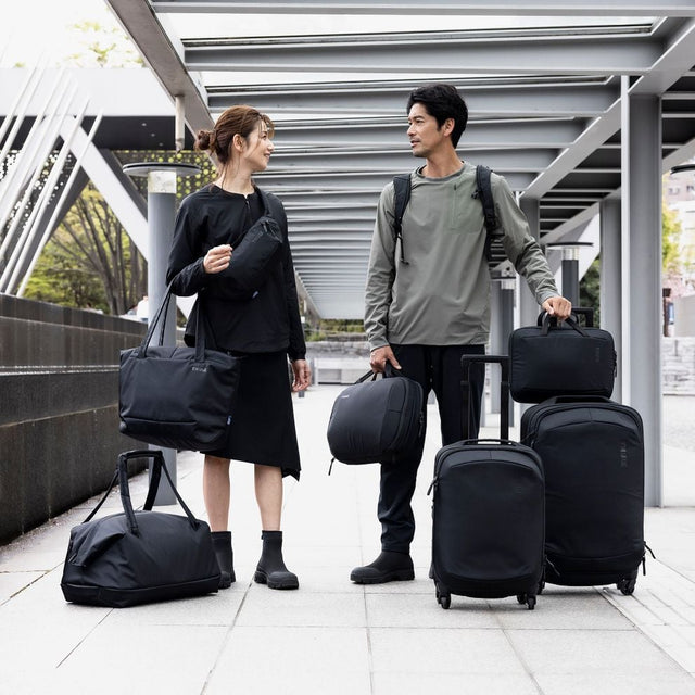 Thule Subterra 2 checked spinner black in use in an airport terminal