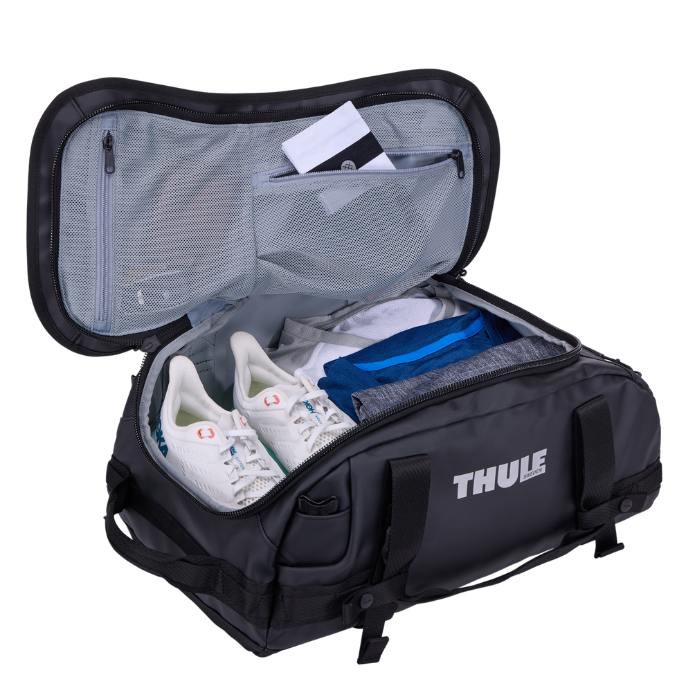 Thule Chasm duffel 30L black opened wide, internal mesh pockets