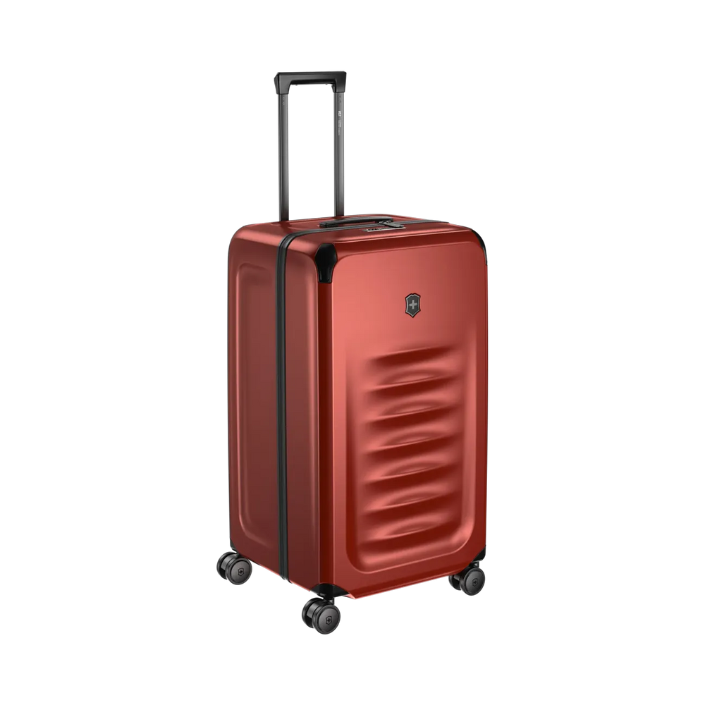Red hardshell rolling suitcase with a textured front panel and retractable handle.