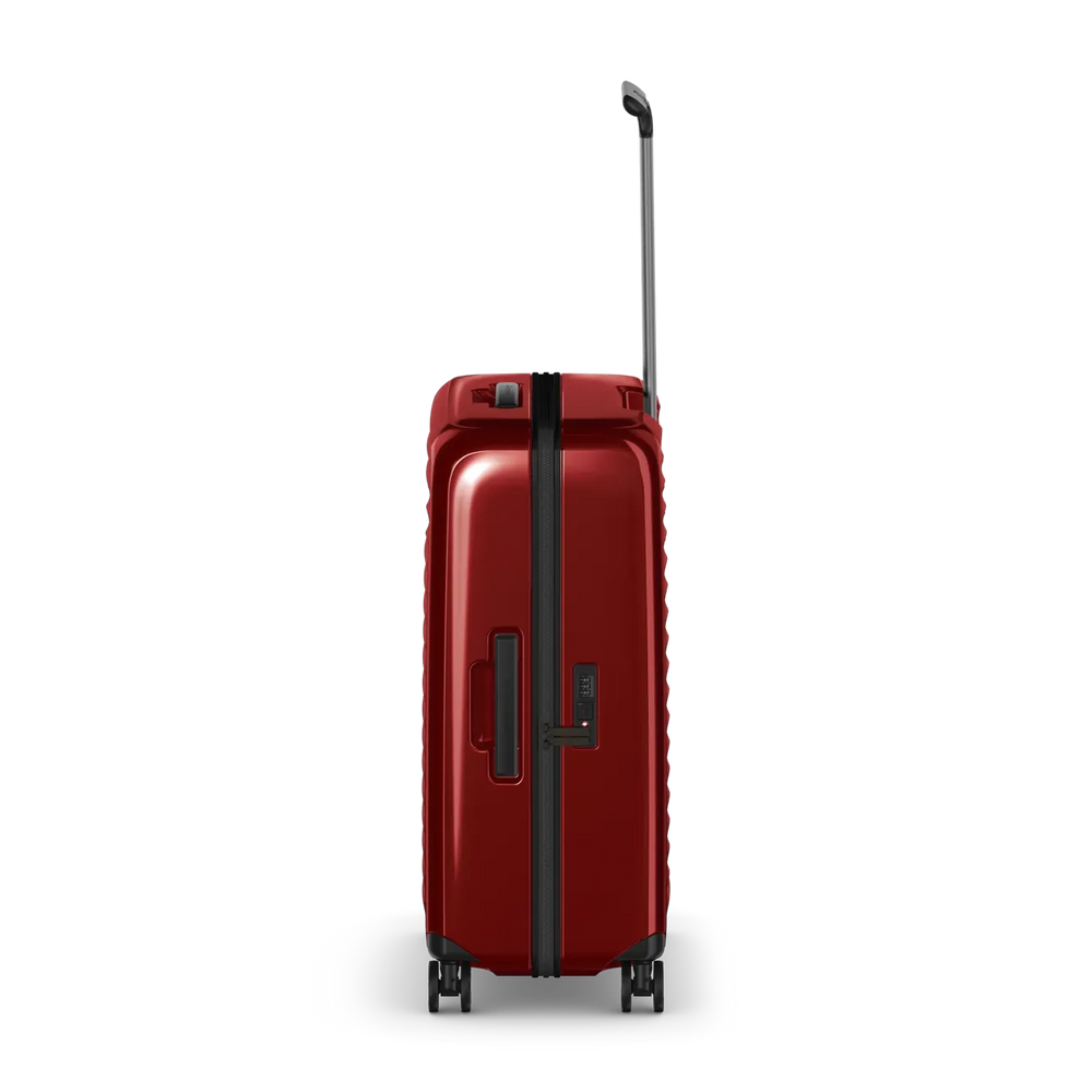 Red hardshell rolling suitcase with an extendable handle and wheels.