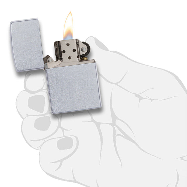 Lit silver metal lighter held in a hand.