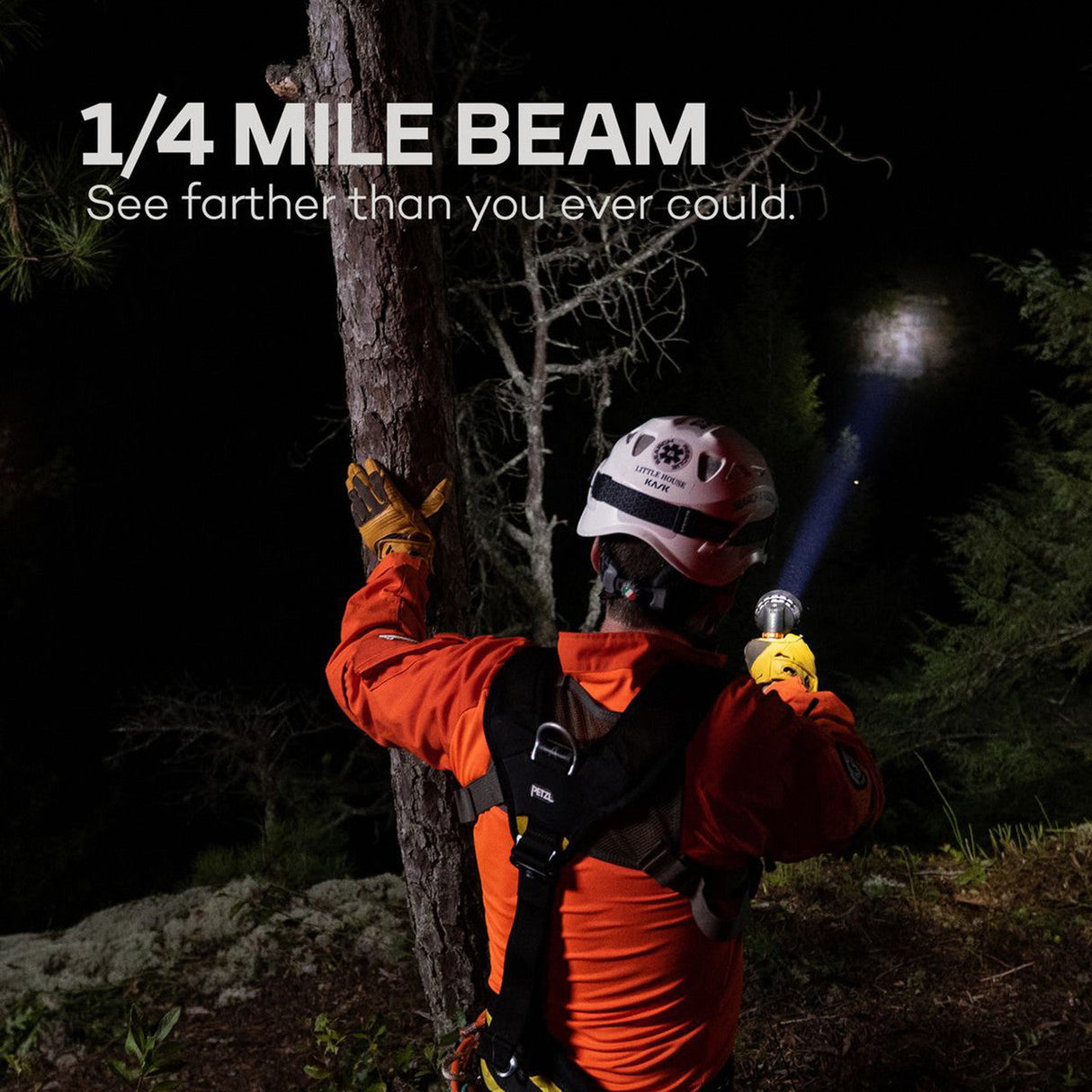 Flashlight being held by a person in safety gear in a dark outdoor setting.