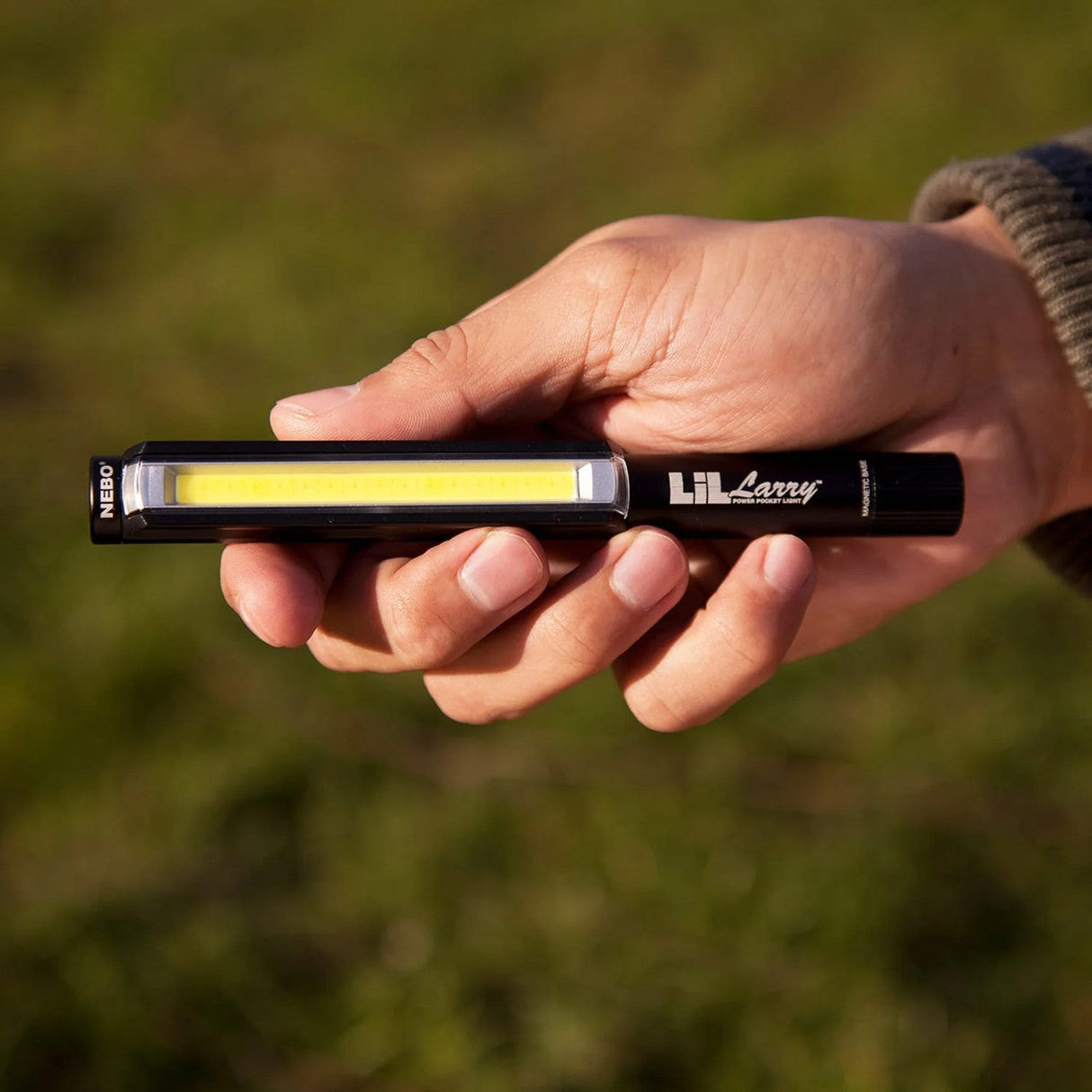 Handheld LED work light or inspection light being held in a person’s hand.