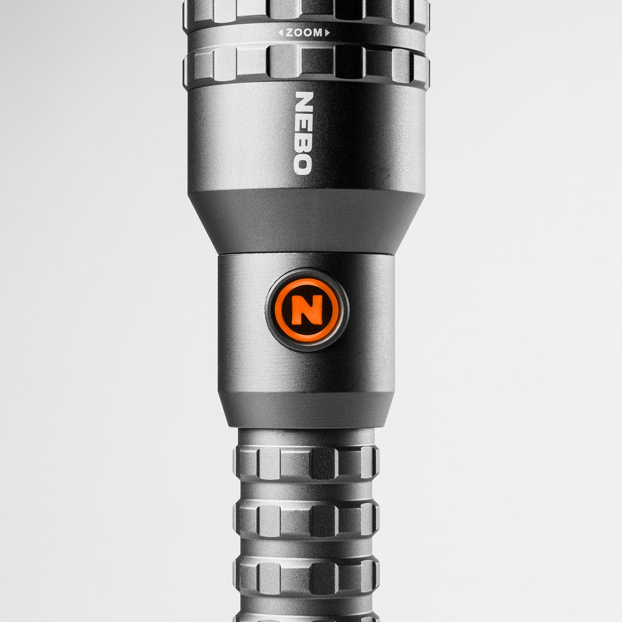 Sleek, metallic flashlight with an orange ’N’ logo and multiple adjustment rings.