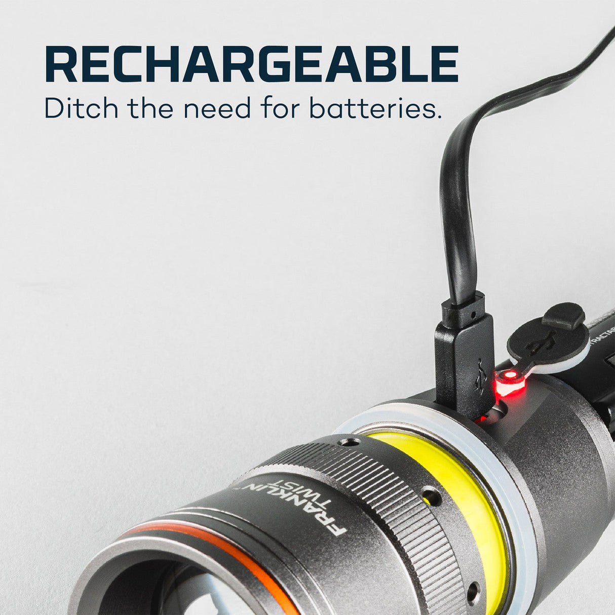 Rechargeable flashlight with a USB charging cable attached.