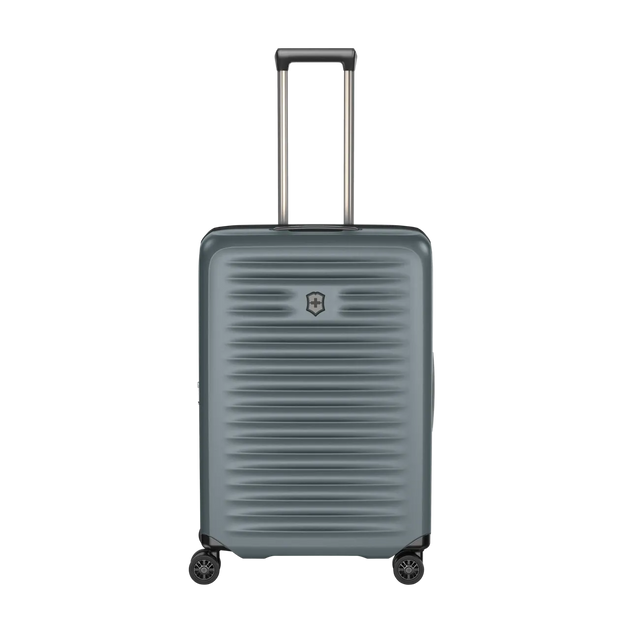 Gray hardshell rolling suitcase with horizontal ridges and an extendable handle.