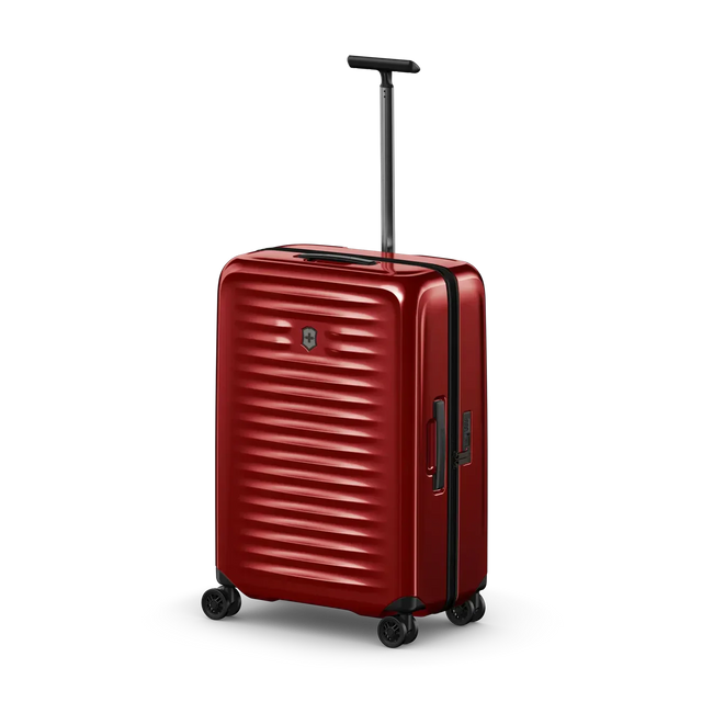 Red hardshell rolling suitcase with horizontal ridges and an extendable handle.