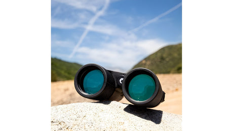 Barska Blackhawk 10x42 waterproof binoculars resting outdoors