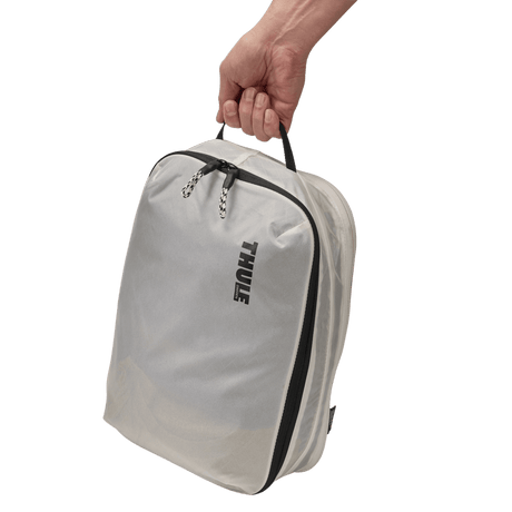 Thule clean dirty packing cube white sitting inside carry-on luggage