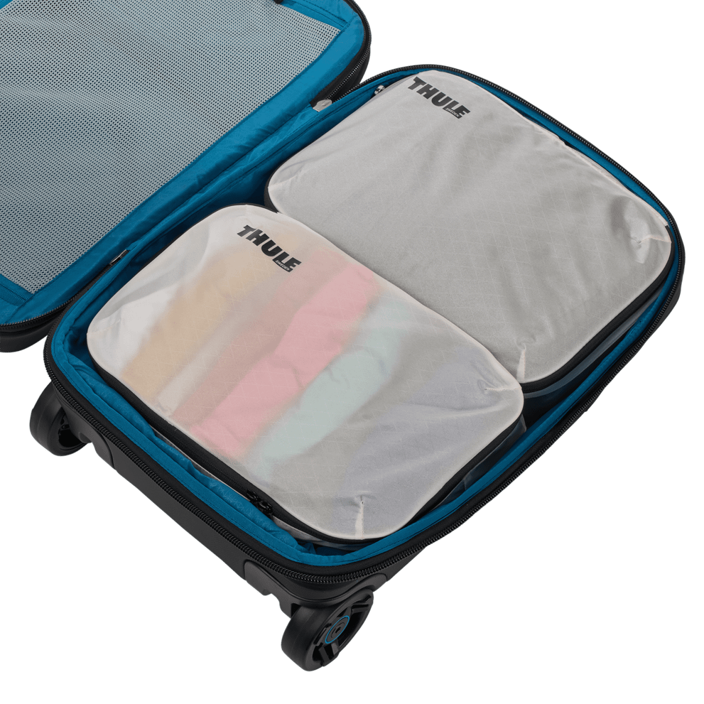 Thule clean dirty packing cube white held by its webbing handle