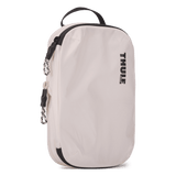 Thule compression packing cube small in white, three-quarter view with the webbing grab handle