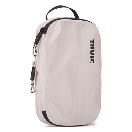 Thule compression packing cube small in white, three-quarter view with the webbing grab handle