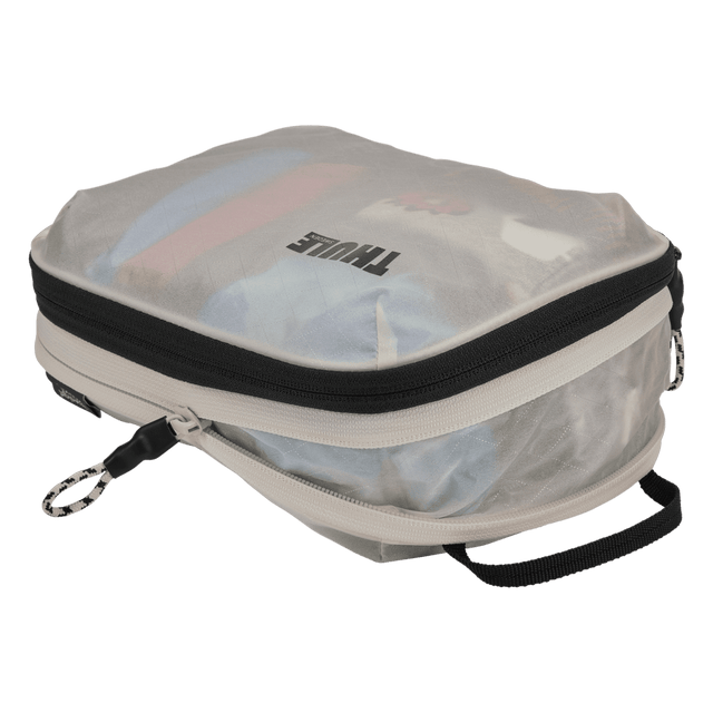 Thule compression packing cube small in white, expanded and loaded with rolled t-shirts