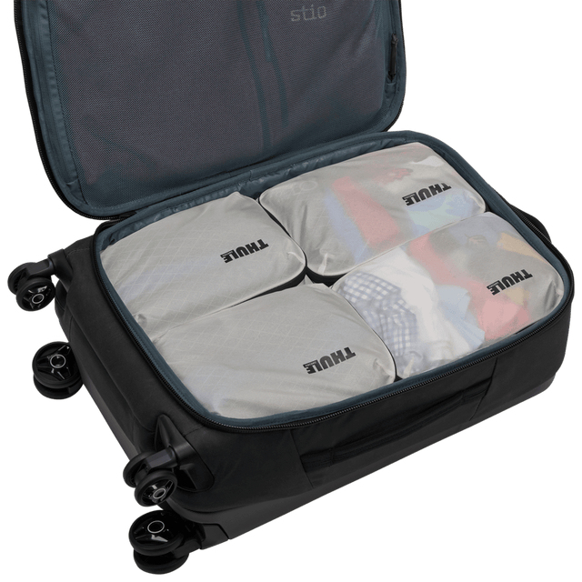 Thule compression packing cube small in white, semitransparent fabric showing socks and underwear