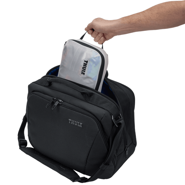 Thule compression packing cube small in white, several cubes arranged inside carry-on luggage