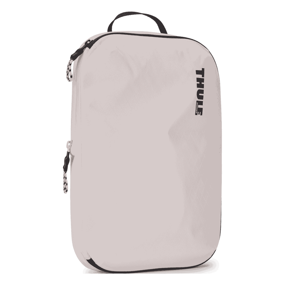 Thule compression packing cube medium in white, angled view showing the webbing handle