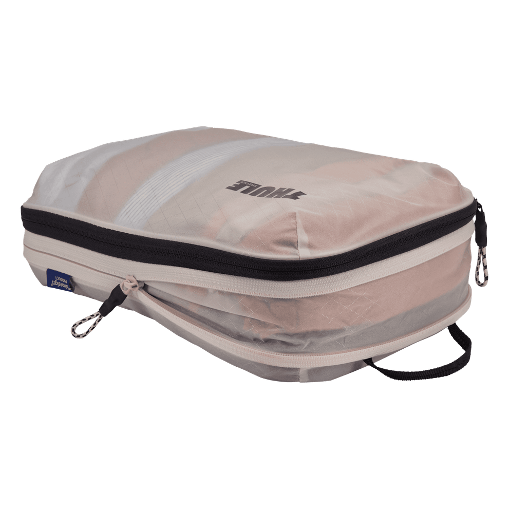 Thule compression packing cube medium in white, expanded and filled with folded clothing