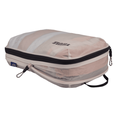 Thule compression packing cube medium in white, expanded and filled with folded clothing