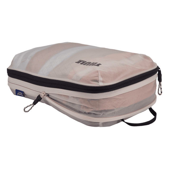 Thule compression packing cube medium in white, expanded and filled with folded clothing