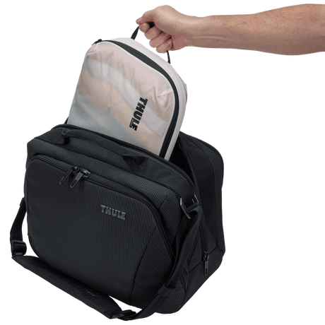 Thule compression packing cube medium in white, packed inside a suitcase