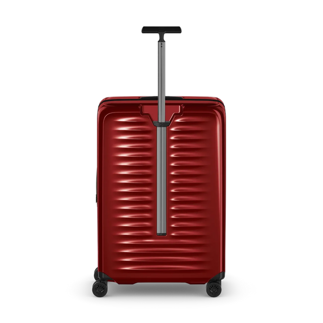 Red hardshell rolling suitcase with horizontal ridges and an extendable handle.