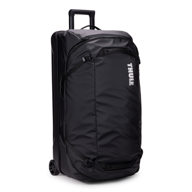Thule Chasm rolling duffel 110L black, angled view with handle extended