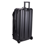 Thule Chasm rolling duffel 110L black, rear view with oversized wheels