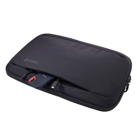 Thule Subterra 2 16in MacBook sleeve in black, laptop being lifted out of the padded compartment