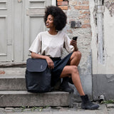 Thule Subterra 2 travel backpack black worn on a city street