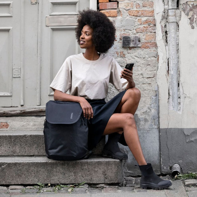 Thule Subterra 2 travel backpack black worn on a city street