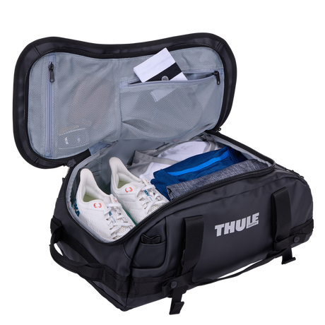 Thule Chasm duffel 30L black opened wide, internal mesh pockets