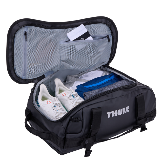 Thule Chasm duffel 30L black opened wide, internal mesh pockets