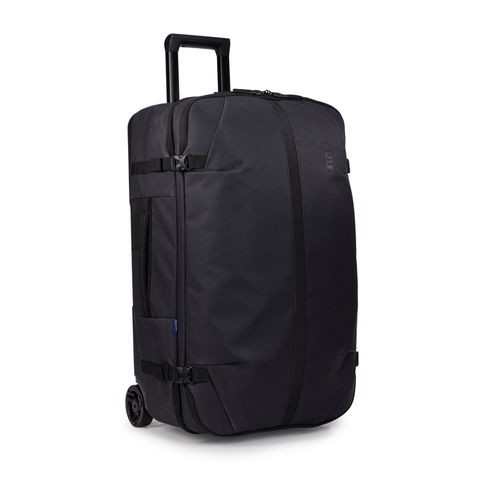 Thule Aion wheeled duffel 70cm black, angled view with telescoping handle extended