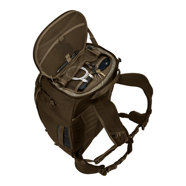 Thule Landmark 60L travel pack in deep khaki, worn on the back on a trail