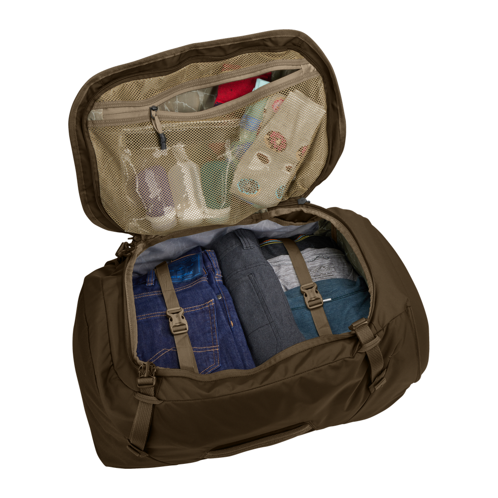 Thule Landmark 60L travel pack in deep khaki, SafeZone compartment holding sunglasses and a phone