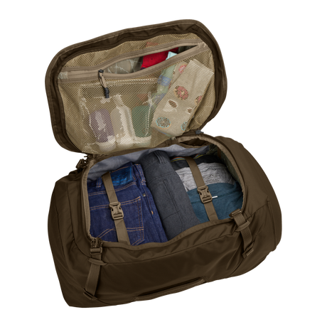 Thule Landmark 60L travel pack in deep khaki, SafeZone compartment holding sunglasses and a phone