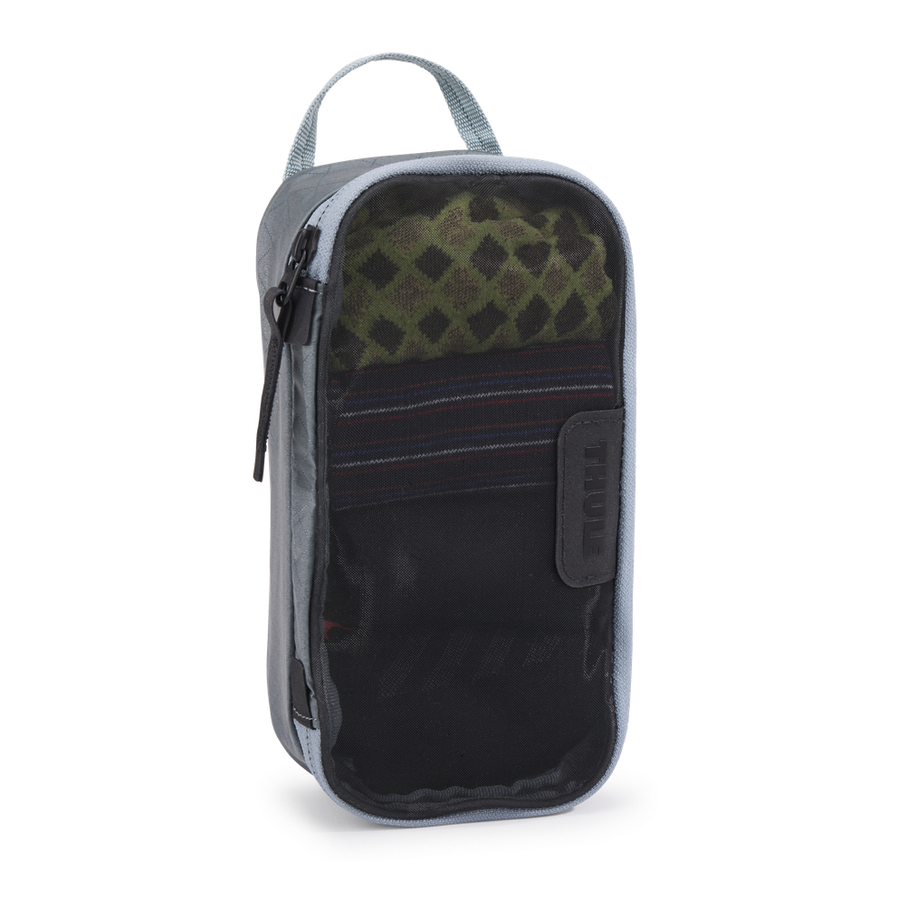 Thule packing cube x-small in Pond Gray, top-down view of the semi-transparent mesh panel