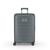 Gray hardshell rolling suitcase with horizontal ridges and a retractable handle.