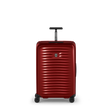 Red hardshell rolling suitcase with horizontal ridges and a retractable handle.