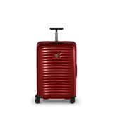 Red hardshell rolling suitcase with horizontal ridges and a retractable handle.