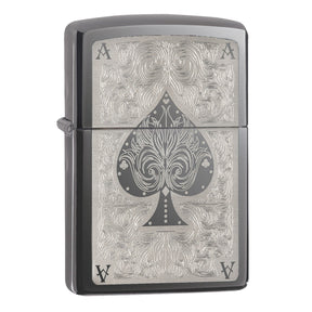 Zippo lighter with an ornate ace of spades design engraved on its surface.