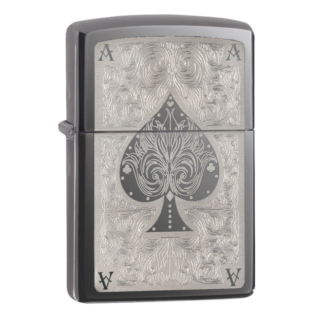 Zippo lighter with an ornate ace of spades design engraved on its surface.