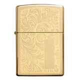 Gold-colored Zippo lighter with an ornate floral engraving pattern.